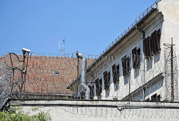 istock Fence and windows of the prison building 636980048