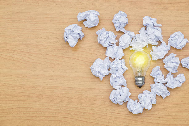 istock Idea concept incandescent bulb with lighting And crumpled paper 636981386
