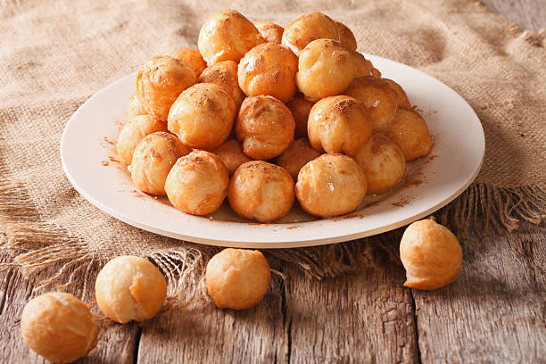 istock Small donuts with honey and cinnamon on the table. horizontal 636982068