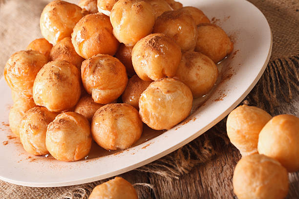 istock Greek dessert loukoumades with honey and cinnamon closeup 636982190