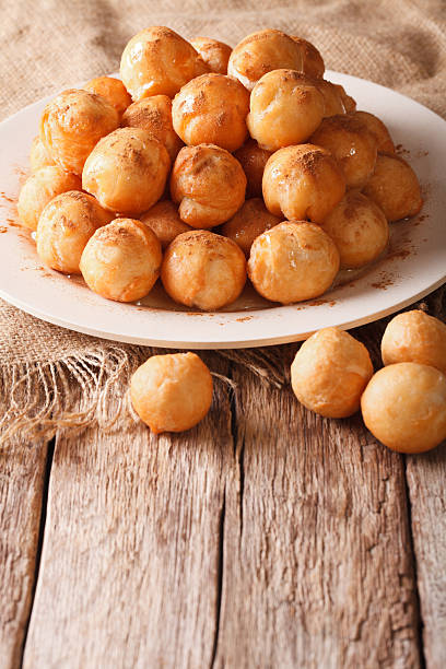 istock Mediterranean cuisine: fried donuts with honey and cinnamon closeup 636982242