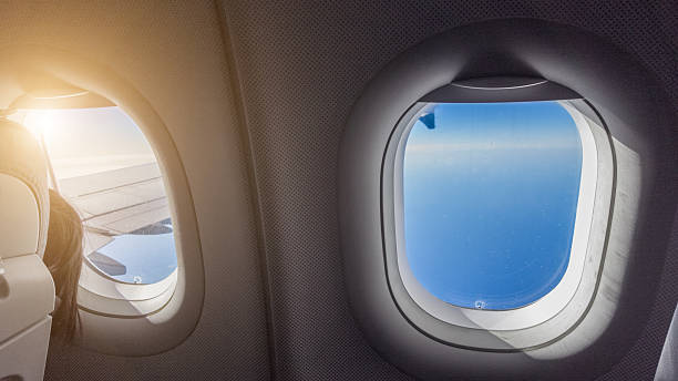 istock airplane - view out of the window with sunlight 636982312
