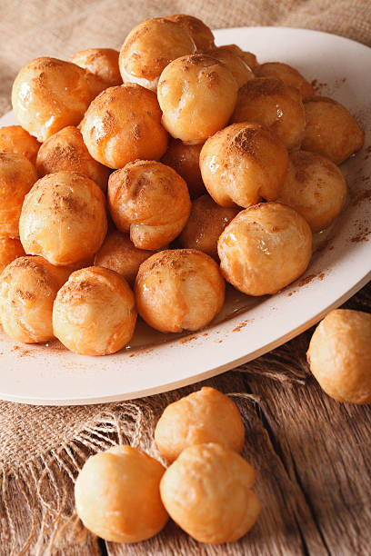 istock Greek loukoumades donuts with honey and cinnamon closeup. vertical 636982330