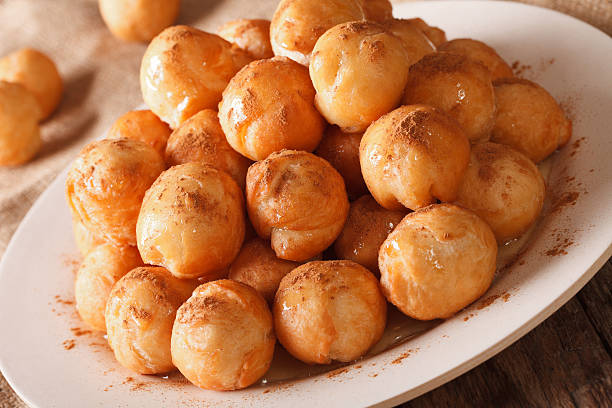 istock loukoumades donuts with honey and cinnamon close-up. Horizontal 636982424