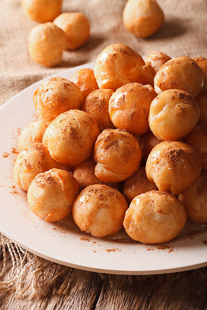 istock loukoumades donuts with honey and cinnamon close-up. vertical 636982462