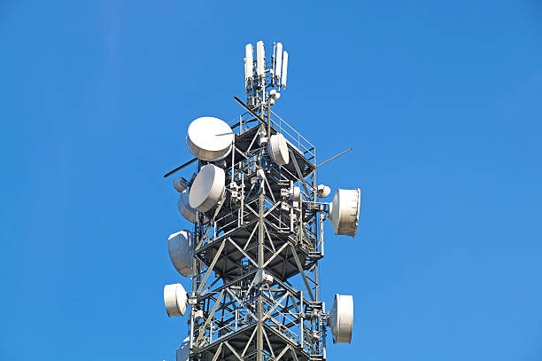 istock Telecommunication pole tower television antennas with blue sky 636985774