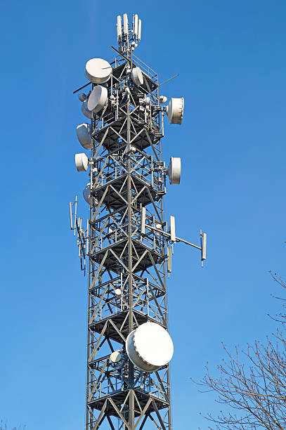istock Telecommunication pole tower television antennas with blue sky 636986344