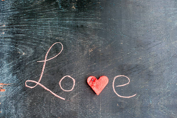 istock Water melon cut into heart shape. Inscription love with chalk. 636986548