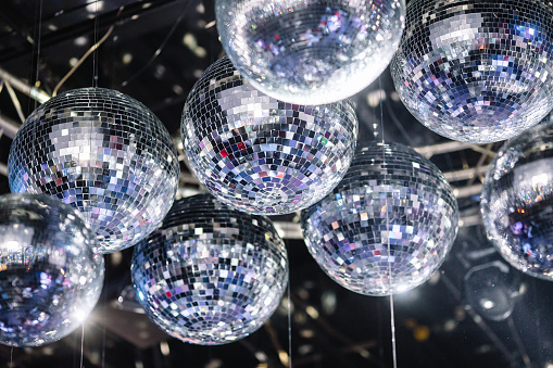 many disco ball on a gray ceiling