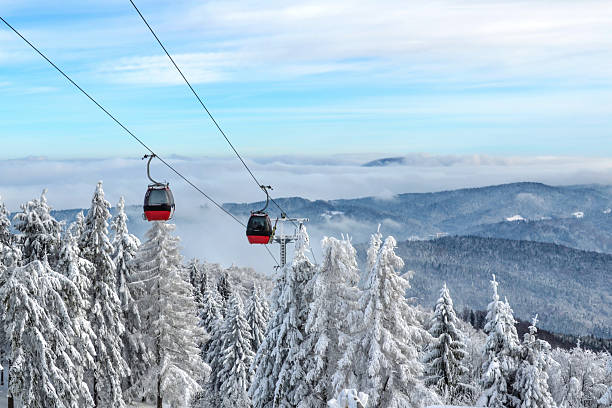 Gondola lift in a ski resort Gondola ski lift on a background of a picturesque winter mountain beskid mountains photos stock pictures, royalty-free photos & images