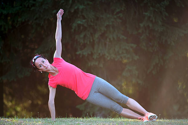 istock Fitness woman stretching on running path at sunset. 636990066