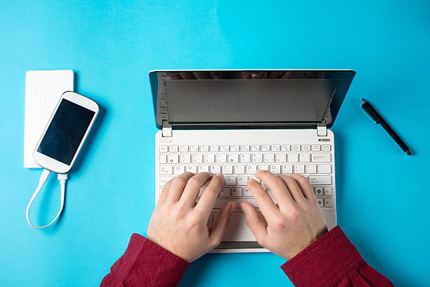 istock male hands typing on a white lap top 636991378
