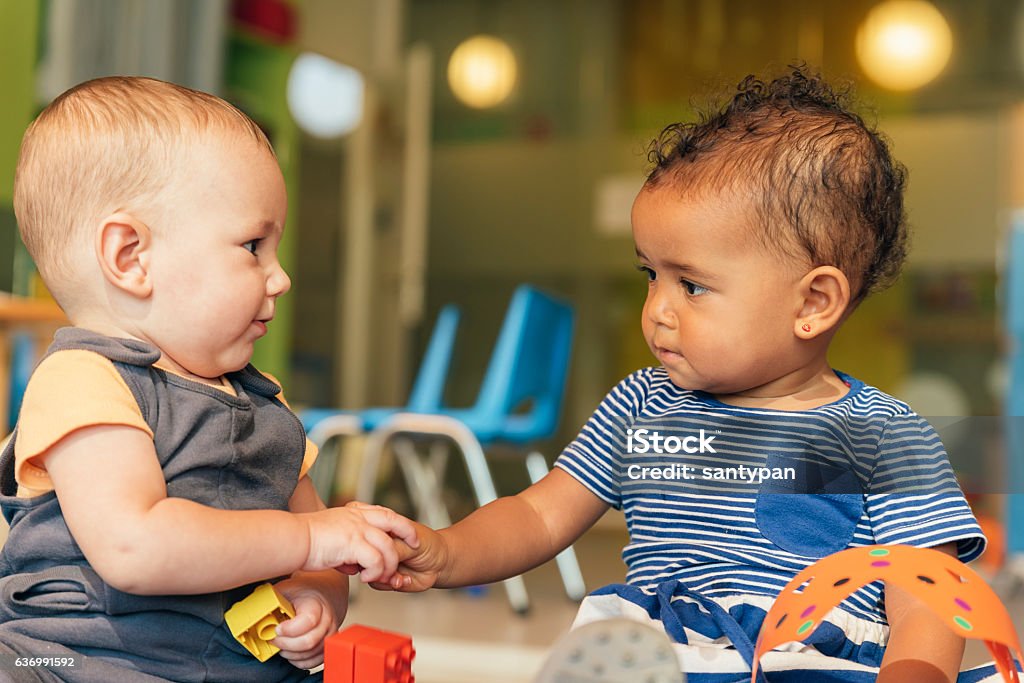 Babys playing together. Babys playing together in the kindergarten. Baby - Human Age Stock Photo