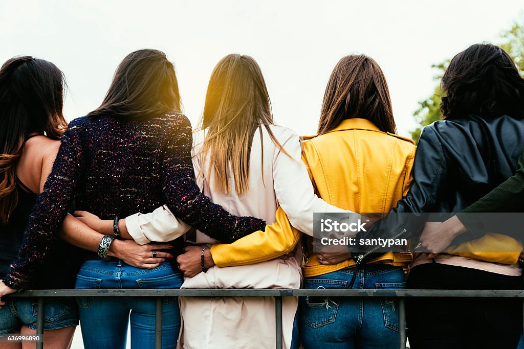 Group of happy friends hugging. Group of happy friends hugging in the street. Women Stock Photo