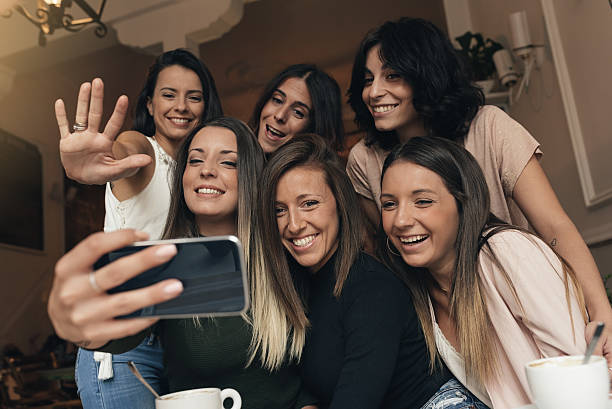 istock Friends taking a photo with a phone. 636996948