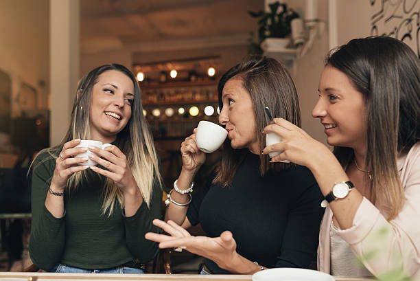 istock Three beautiful women drinking coffee and chatting. 636996966