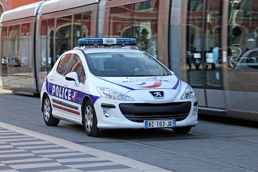Nice, France - April 13th, 2011: Peugeot 308 police car in motion on the street. This vehicle is used to patrols on the streets.