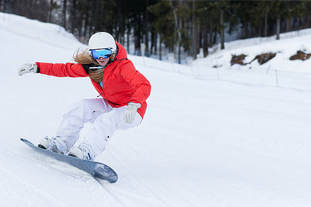 Ssnowboarder on slopes in the sunny morning Woman snowboarder on the slopes frosty winter day. Beautiful girl on snoborde in the snow. skiing and snowboarding stock pictures, royalty-free photos & images