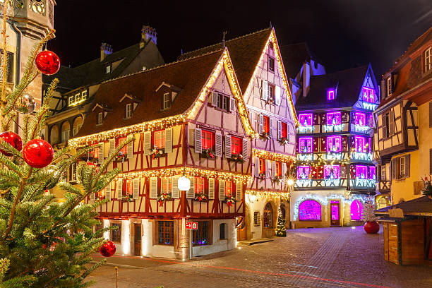 Christmas street at night in Colmar, Alsace, France Traditional Alsatian half-timbered houses in old town of Colmar, decorated and illuminated at christmas time, Alsace, France alsace stock pictures, royalty-free photos & images