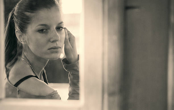istock young woman and window 637009746