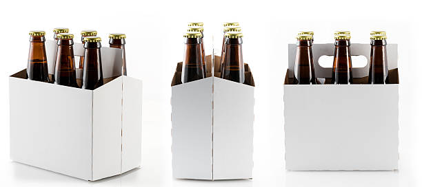 Six bottles of beer in cardboard carrier Three different views of six beer bottles in cardboard container with gold caps with reflection in shiny white base six pack stock pictures, royalty-free photos & images