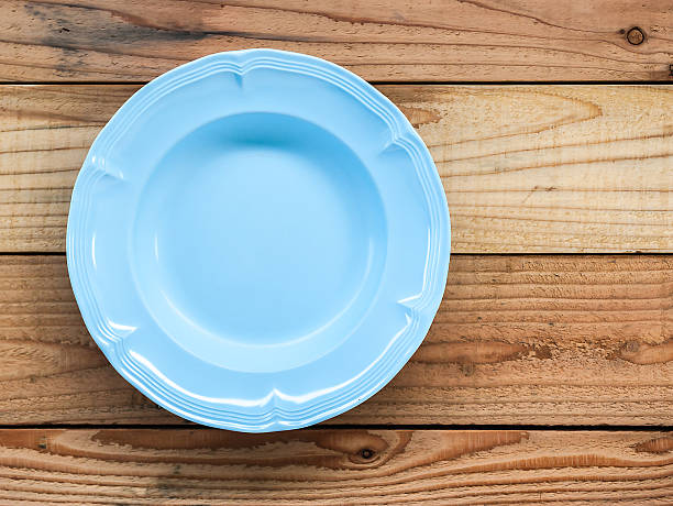 istock Empty blue plate and  on wooden background 637014666