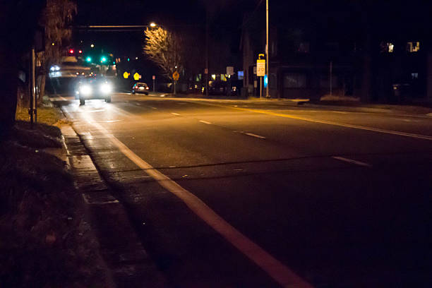 istock Car headlights, Driving on a residential road at night 637014896