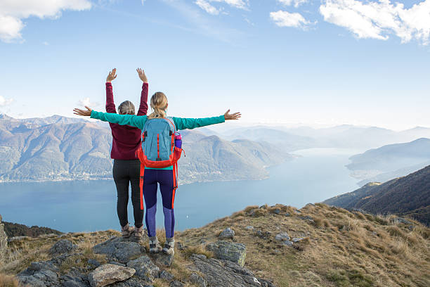 istock Hikers reaching mountain top  and celebrating 637015876