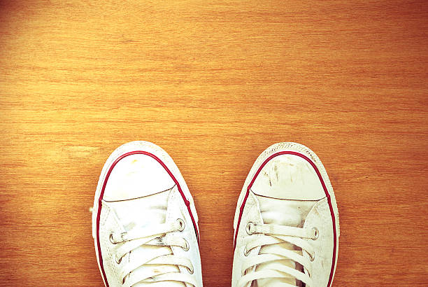 istock Top view of old sneaker on wooden floor 637016300