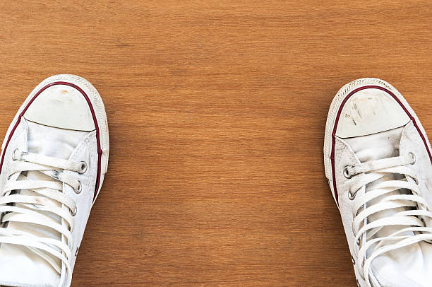 istock Top view of old sneaker on wooden floor 637016320