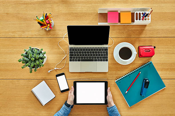 istock Woman using tablet computer by office supplies, coffee and houseplant 637018278
