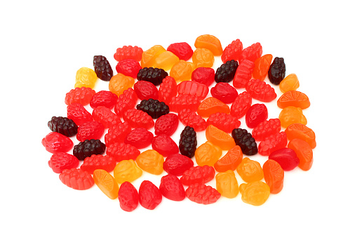 Photograph of fruit flavored gummy snacks set against a white background.