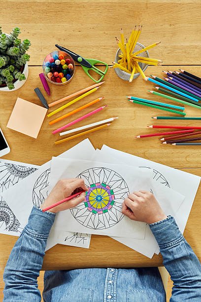 istock Woman drawing by various artist tools on wooden table 637018740