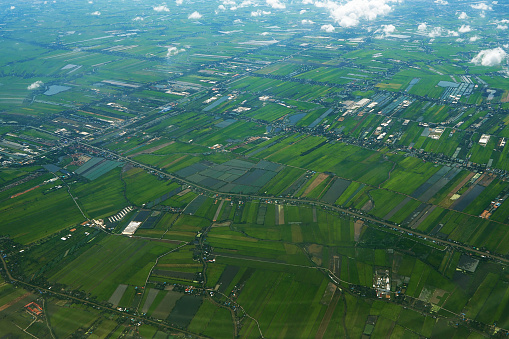 Aerial view from a flying plane in the sky over Bangkok country field, Thailand