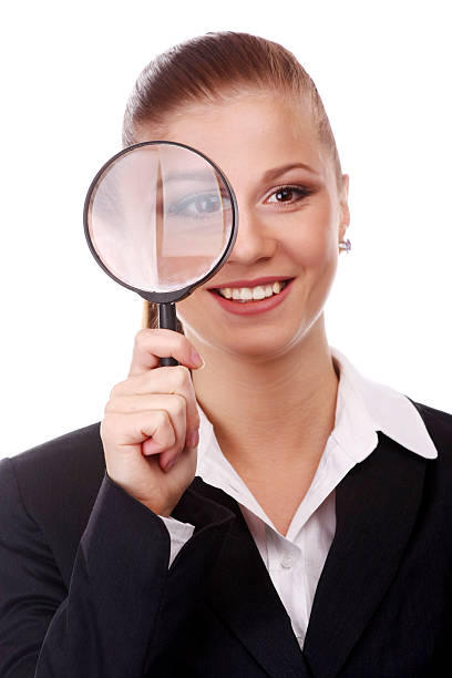 istock businesswoman with magnifying glass 637019780
