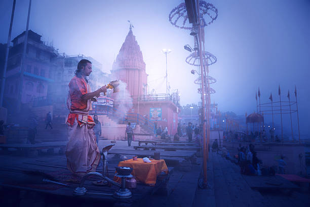 Hindu priests perform an worship, Varanasi. Varanasi, India - December 13, 2015: Hindu priests perform an Arti worship ceremony at  Ganges River, Varanasi, Uttar Pradesh, India ghat photos stock pictures, royalty-free photos & images