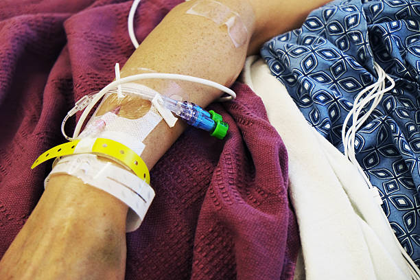 istock Needle and Tubes in a Patient Arm 637021486