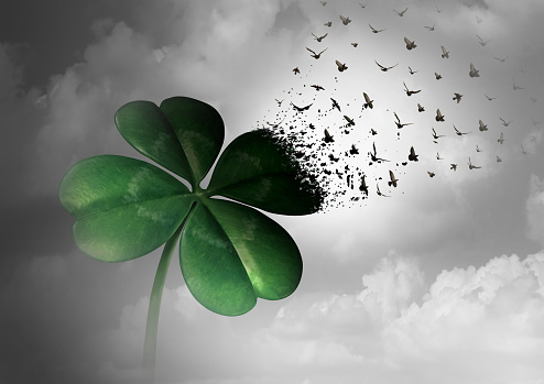 Losing luck or spreading good fortune concept as a four leaf clover transforming into flying birds as a surreal communication metaphor for financial and life success or decay loss and failure  with 3D illustration elements.