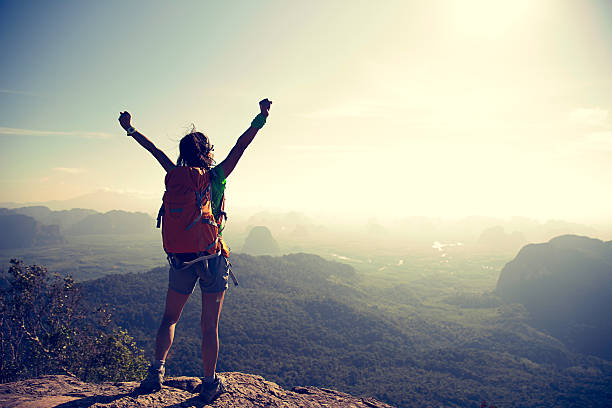 istock young woman backpacker hiking at seaside mountain cliff 637026592