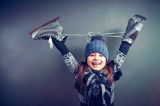 Photo of Little girl with skates isolated on background