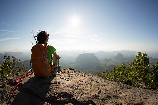 istock young woman backpacker hiking at seaside mountain cliff 637029668