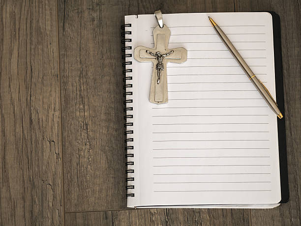 istock The silver crucifix and a pen on the a blank note 637029964