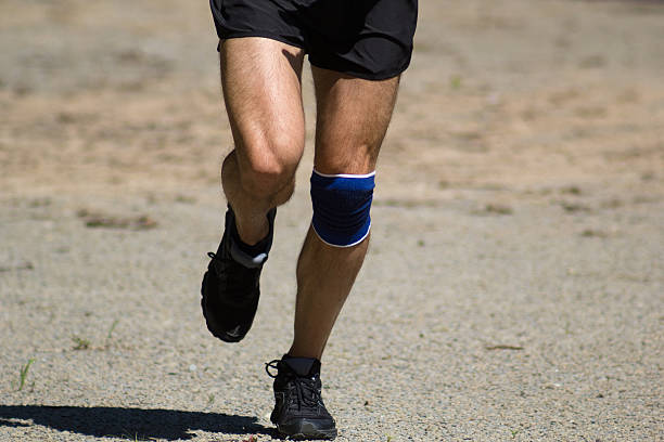 istock Athletic male feet running on road 637031280