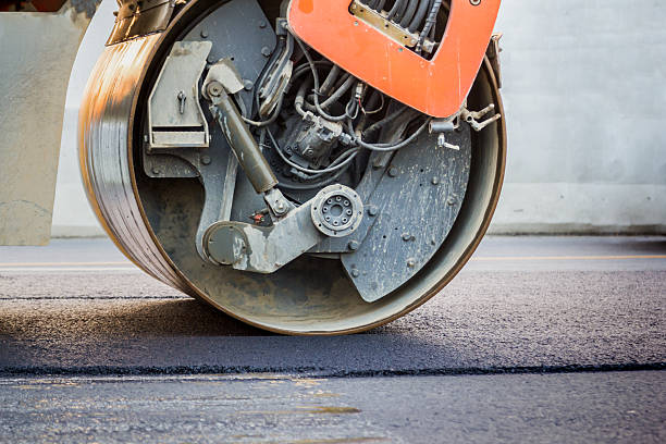 istock road roller working on the new asphalt road 637032312