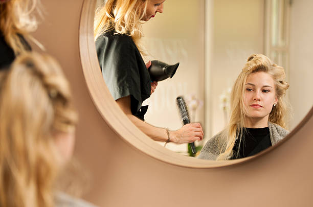 istock professional hair stylist at work - hairdresser  doing hairstyle 637034708