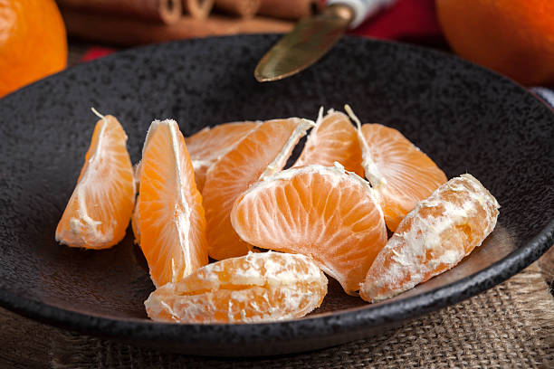 istock Peeled tangerine on the wooden table. 637037332