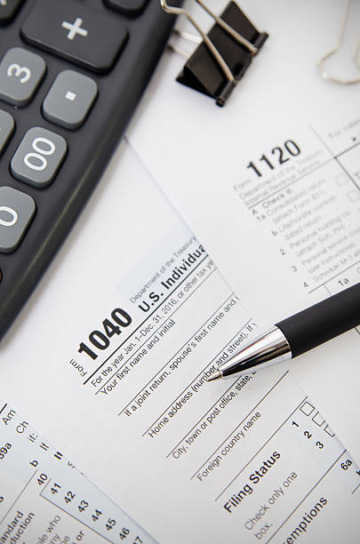 istock US tax form 1040 with pen and calculator 637039384
