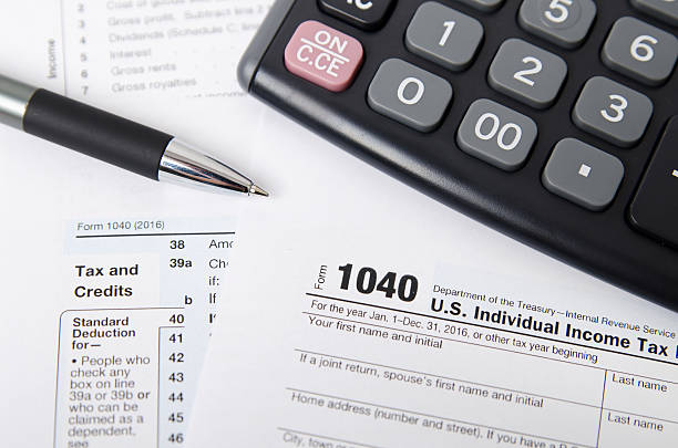 istock US tax form 1040 with pen and calculator 637039420