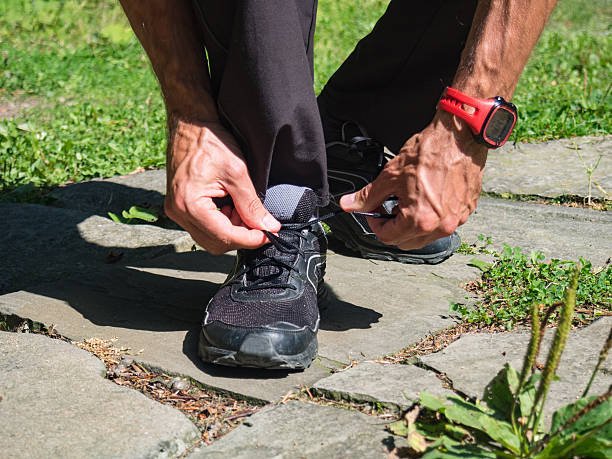 istock Male runner tying shoelaces 637041890