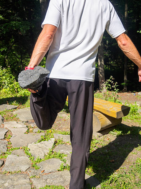 istock Caucasian male runner stretching outdoors in forest 637041958